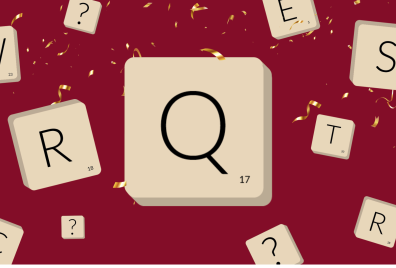 Large letter Q on a tile surrounded by smaller tiles with various letters