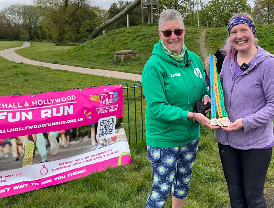 Marie and Abi pose wih Wythall Fun Run medals