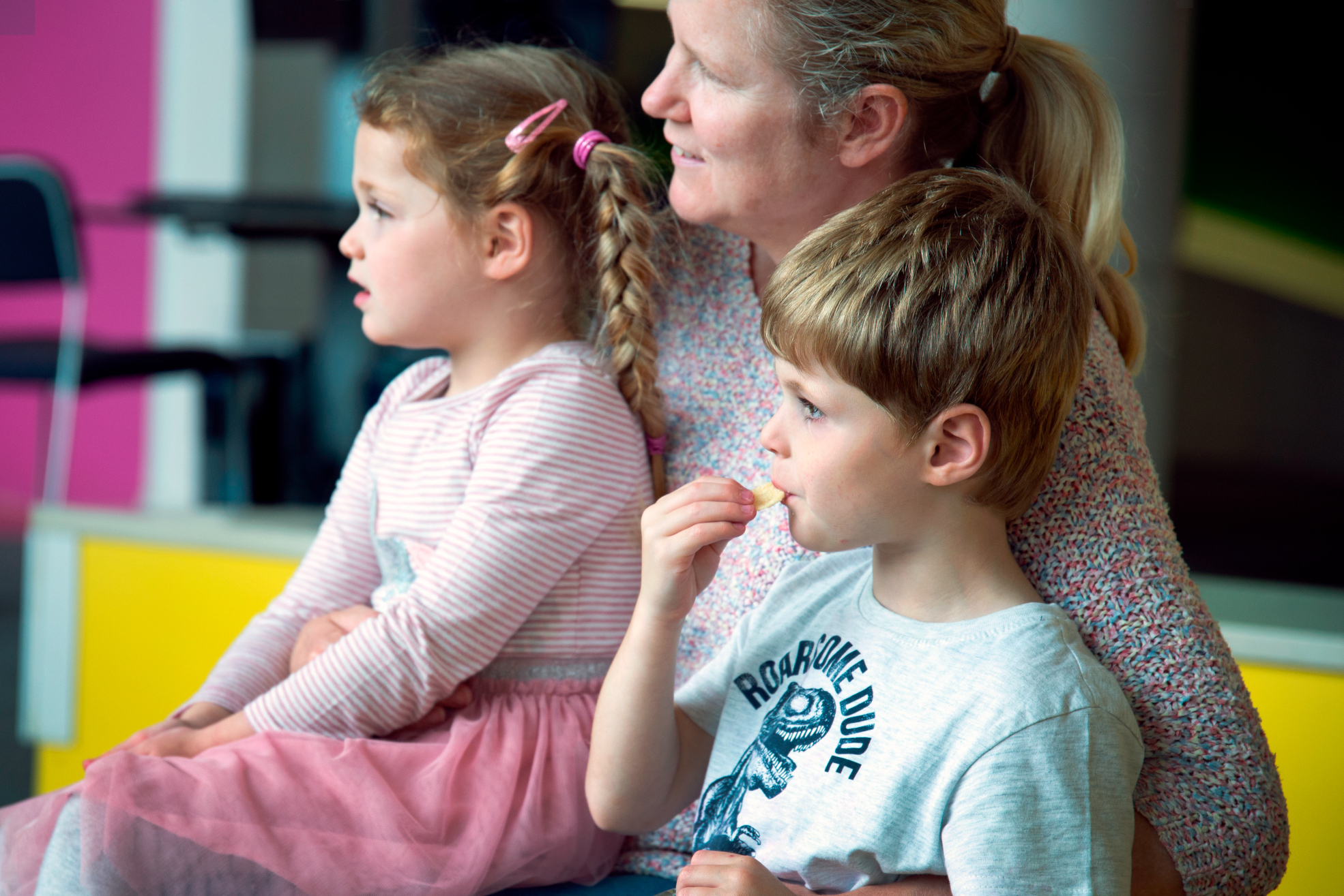A mother and two children listening to a story