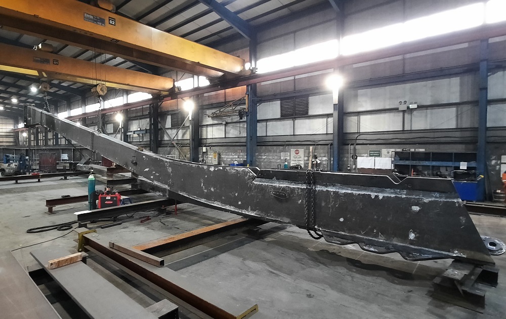 A large pylon from the bridge being worked on in a workshop 