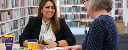 women talking in the library
