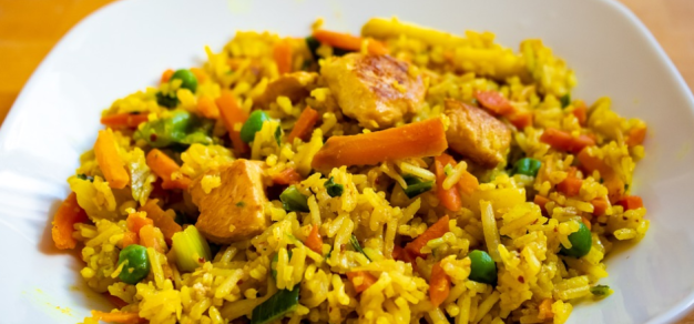 Flavoured rice dish served with vegetables served on a plate