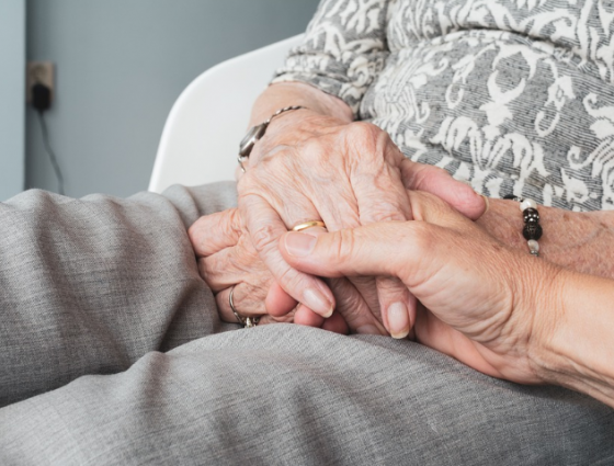 close up of two older people holding hands