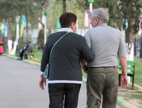 two people walking together arms linked for support