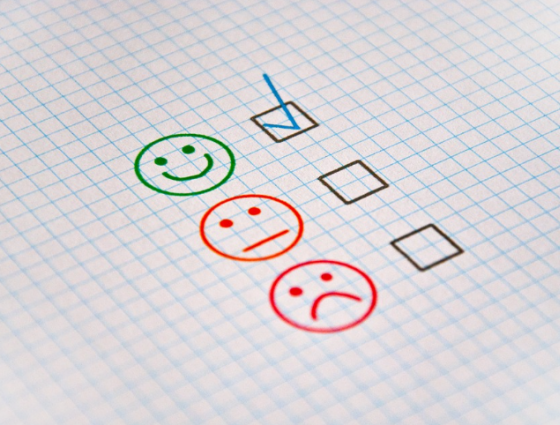 Feedback icons with happy face, plain face and sad face
