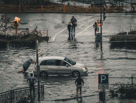 Car being pushed through a flood