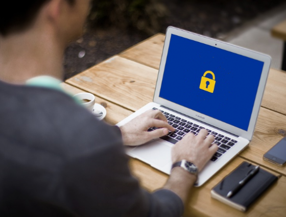 person on a computer with a padlock icon showing on the screen