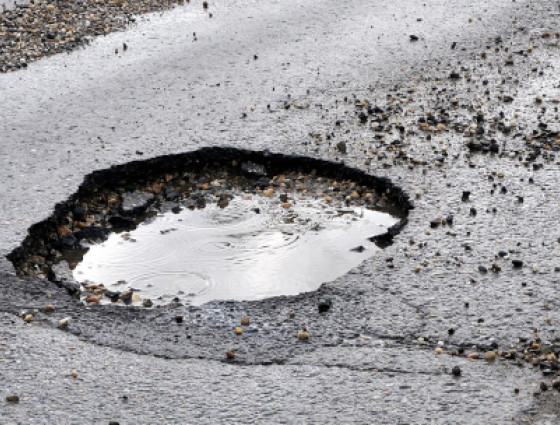 Pothole filled with water on a road