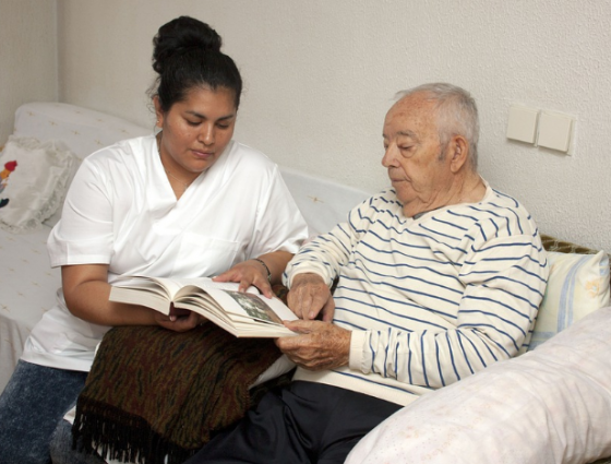 carer and a man looking at a book