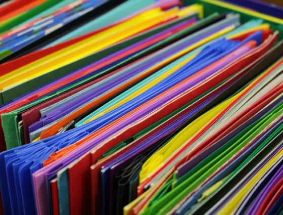 close up of colourful folders in a draw