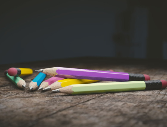 A selection of coloured pencils placed on a desk