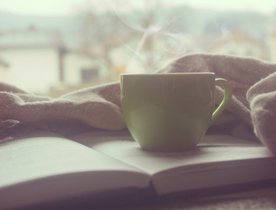 A cup of coffee sat on an open book