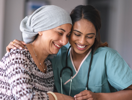 Healthcare professional supporting a lady with headscarf on
