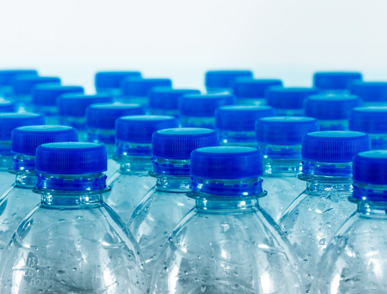 Rows of plastic bottles with blue tops.