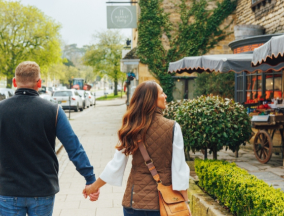 Photograph of a man and woman walking down Broadway High Street