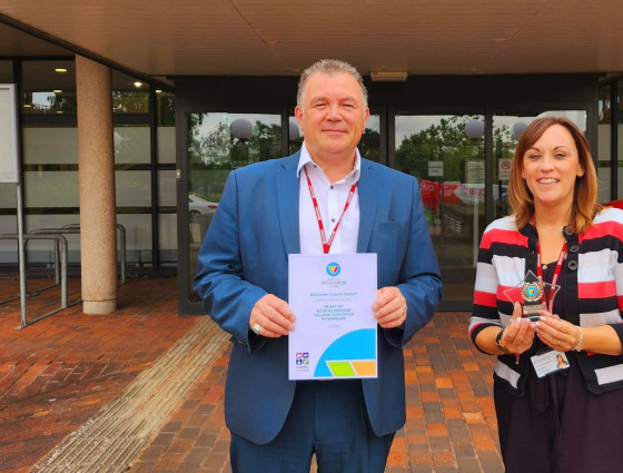 David Harrison and Claire Sedgwick pose with HOW award outside of County Hall