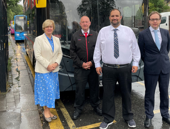 David Bradford and Andy Lunn from National Express standing next to a bus with councillors Mike Rouse and Karen May.  