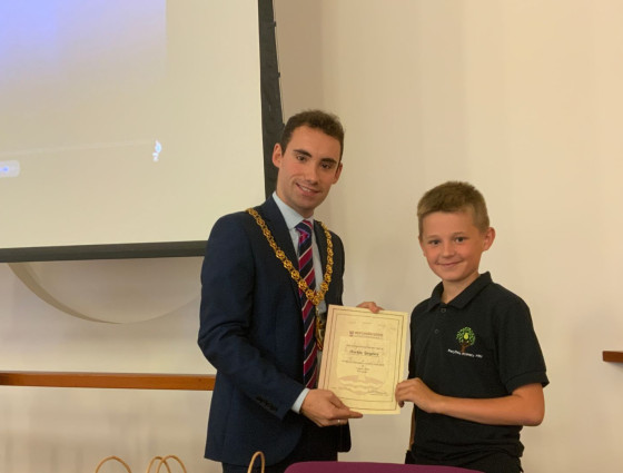 Worcestershire County Council Chairman Kyle Daisley hands a certificate and gift bag to Perryfields Primary PRU pupil Archie Joyner 