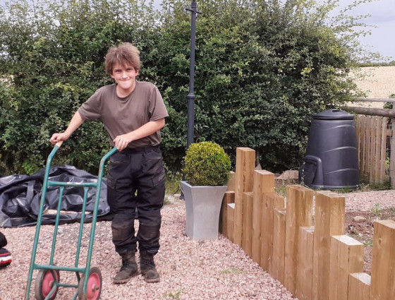 Dan wheeling a wheelbarrow at the Flyford 