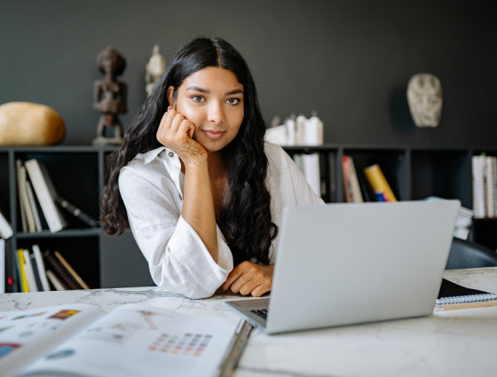 Lady sat at her computer smiling at the camera