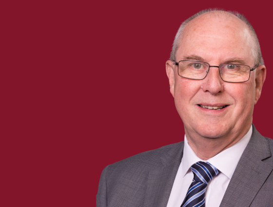 Photograph of Cllr Steve Mackay superimposed onto a burgundy background