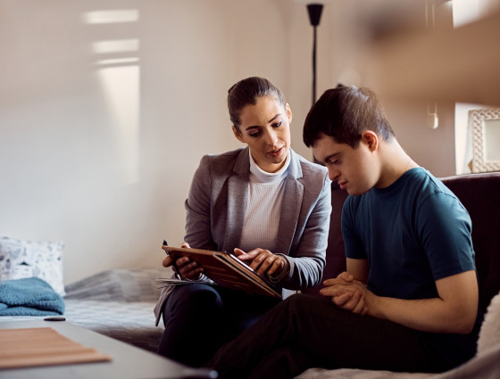 Lady showing a man something on a computer screen