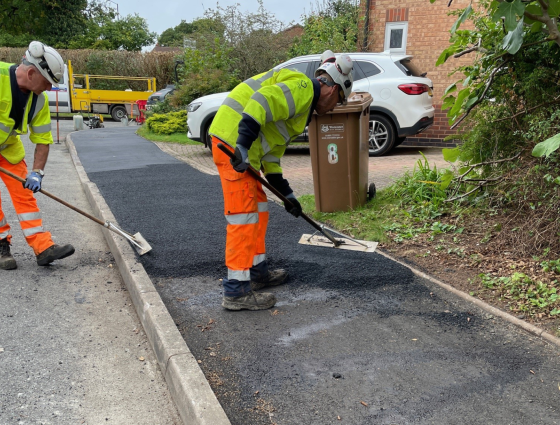 Highway workers repairing a footway