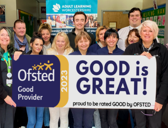 Staff and learners at Adult Learning and Young Adult Learning stand in a group facing the camera holding a large banner that reads "GOOD is GREAT, proud to be rated good by OFSTED"