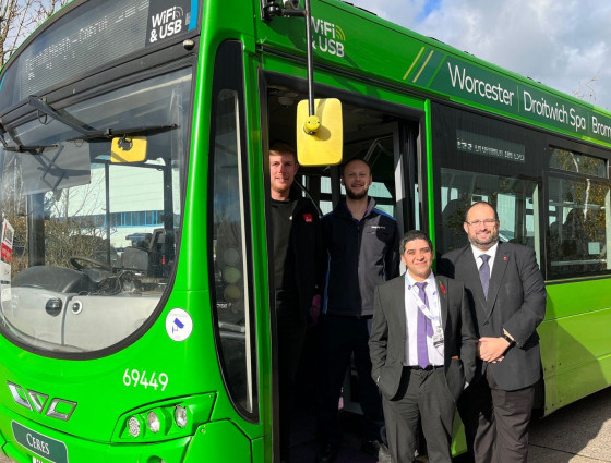 Guests pose on one of the new buses