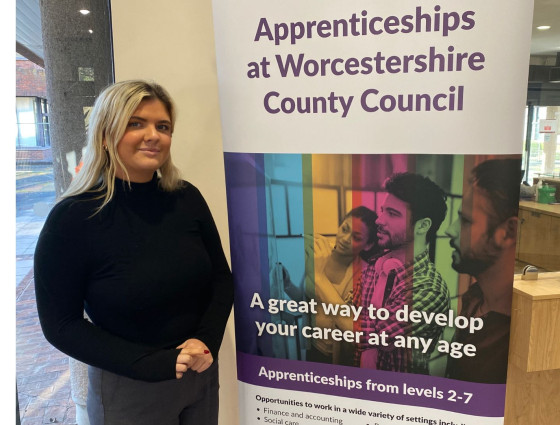 Bethan stands with WCC apprenticeships banner