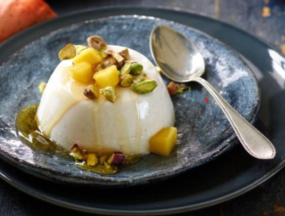 Picture of pudding with mango & pistachios on top
