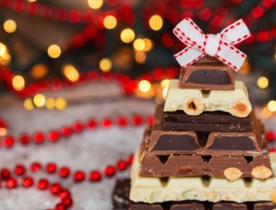 Chocolate covered squares with Christmas lights in background
