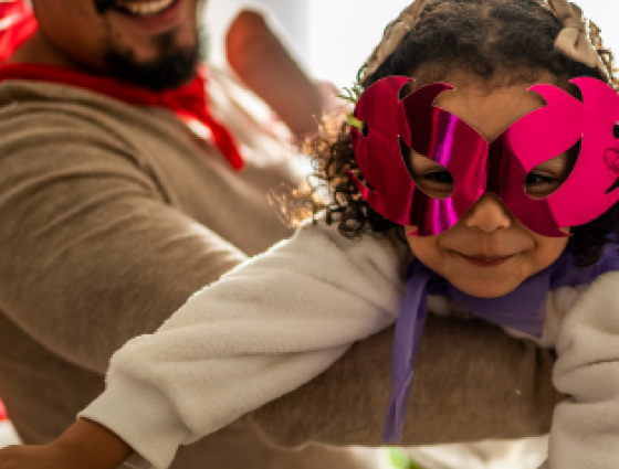 Child and parent dressed as a superhero