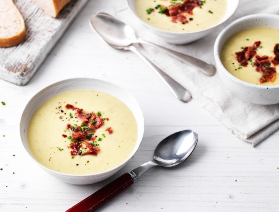 Bowl of soup with crispy prosciutto on top