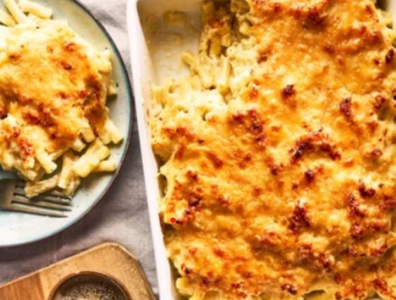 Dish with macaroni cheese & portion on plate