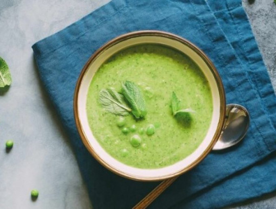 Bowl of soup with peas on top