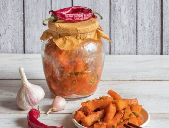 Jar of kimchi with garlic & pumpkin on the side