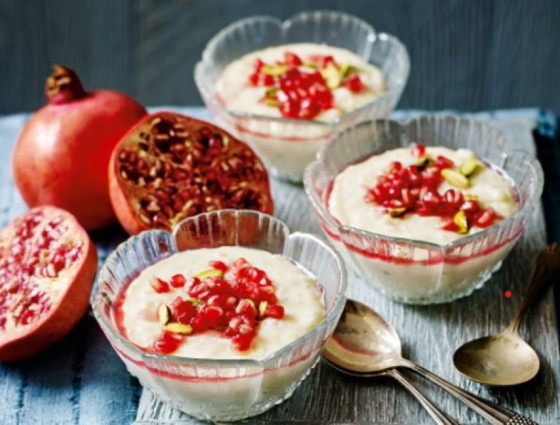 Glass bowls with rice pudding topped with pomegranates