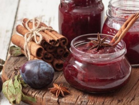 Jar of jam with plums & cinnamon sticks 