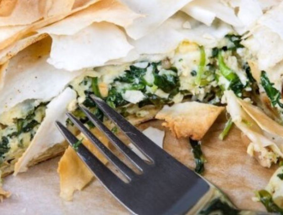 Slice of pastry and vegetables with a fork in the middle