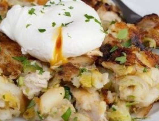 Plate of potato hash with poached egg on top