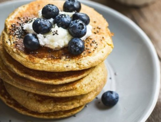 Stack of pancakes with fruit on top