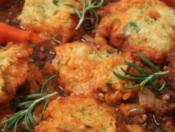 Bowl of stew with dumplings and herbs