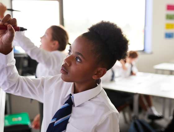 Children drawing on a whiteboard