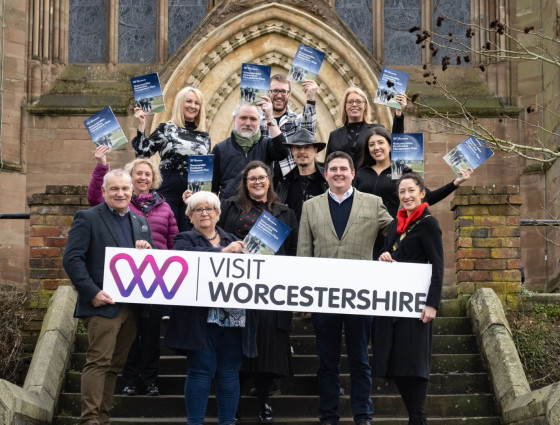 Partners pose with the Destination Management Plan outside Worcester Cathedral