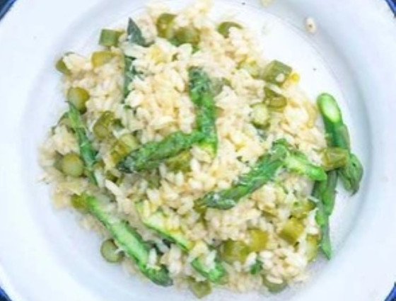Plate of risotto with asparagus on top