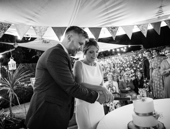 Sam and Adam cutting wedding cake