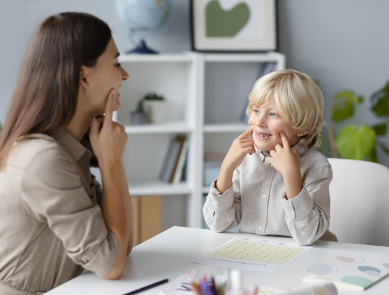 Image of a woman and child practicing speech therapy