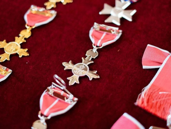 Honours medals laid out on red cloth