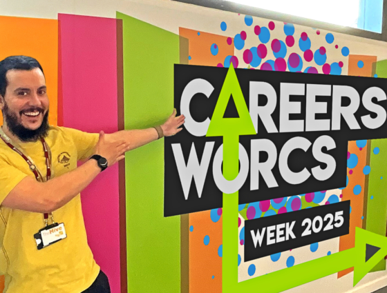 A member of staff highlighting the Careers Worcs Week 2025 sign.